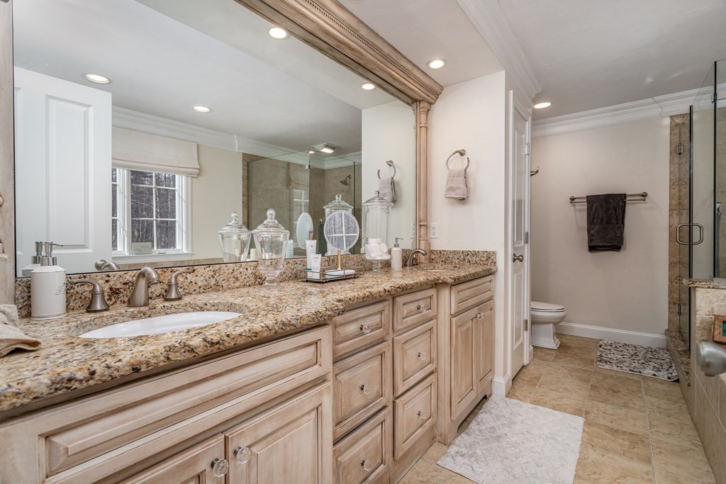 298 Harvard Road Bolton, MA 01740 - Photo 28 of 42 a bathroom with a granite countertop sink a toilet and a large mirror
