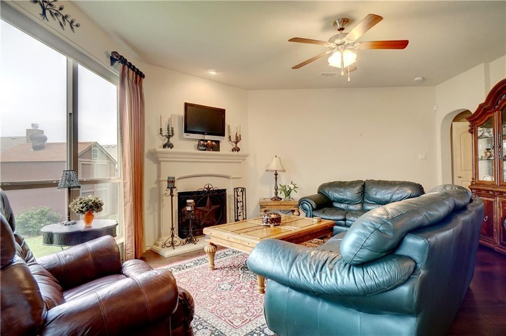 13212 Larks View Point Fort Worth, TX 76244 - Photo 16 of 36 a living room with furniture a fireplace and a flat screen tv