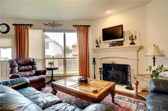 a living room with furniture a fireplace and a flat screen tv