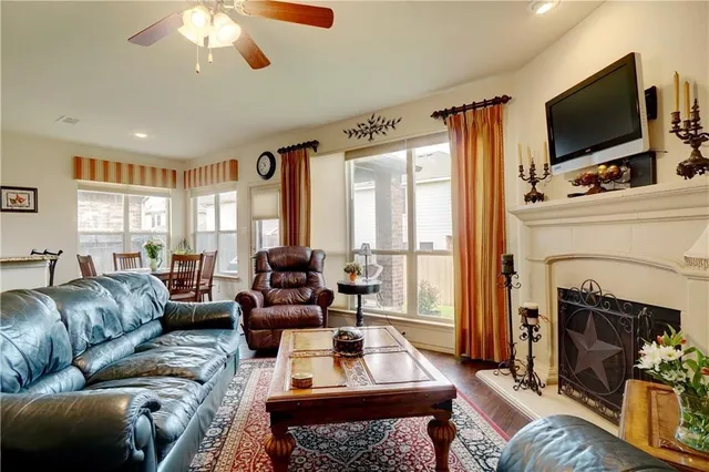 a living room with furniture a flat screen tv and a fireplace