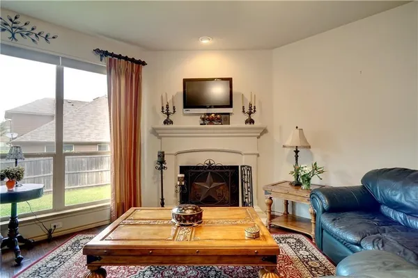a living room with furniture fireplace and window