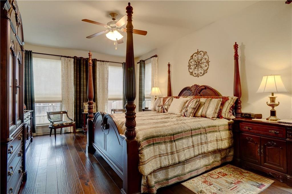 13212 Larks View Point Fort Worth, TX 76244 - Photo 21 of 36 a bedroom with a bed and wooden floor