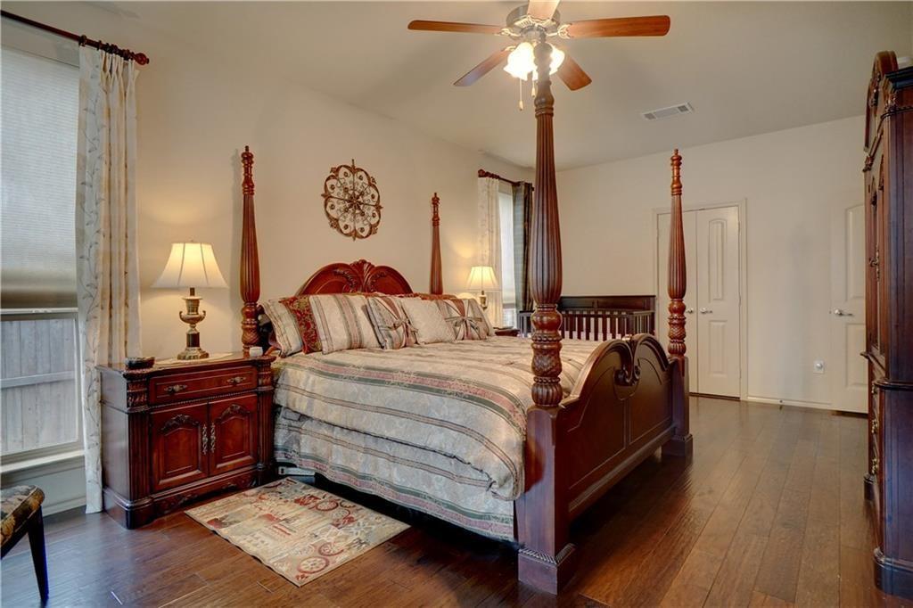 13212 Larks View Point Fort Worth, TX 76244 - Photo 22 of 36 a bedroom with a bed and a chandelier
