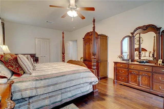 a bedroom with bed and wooden floor