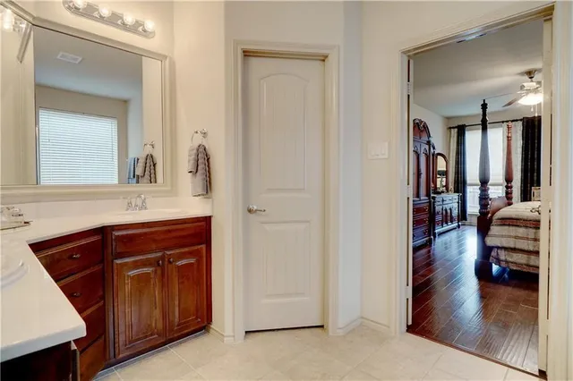 a en suite bathroom with a sink and a mirror