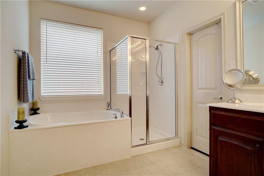13212 Larks View Point Fort Worth, TX 76244 - Photo 26 of 36 a bathroom with a tub sink and mirror