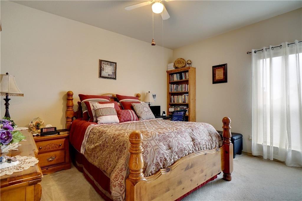 13212 Larks View Point Fort Worth, TX 76244 - Photo 27 of 36 a bedroom with a bed and a chandelier