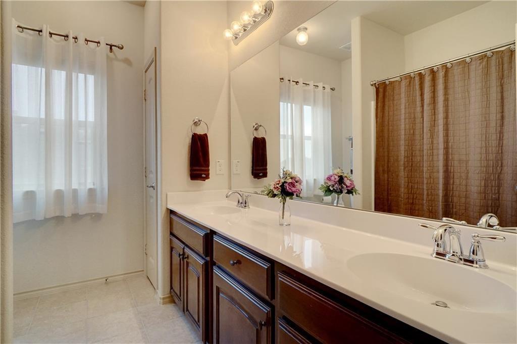 13212 Larks View Point Fort Worth, TX 76244 - Photo 30 of 36 a bathroom with a double vanity sink and a mirror
