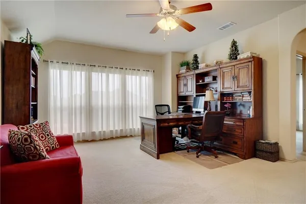 a view of a livingroom with workspace and a window