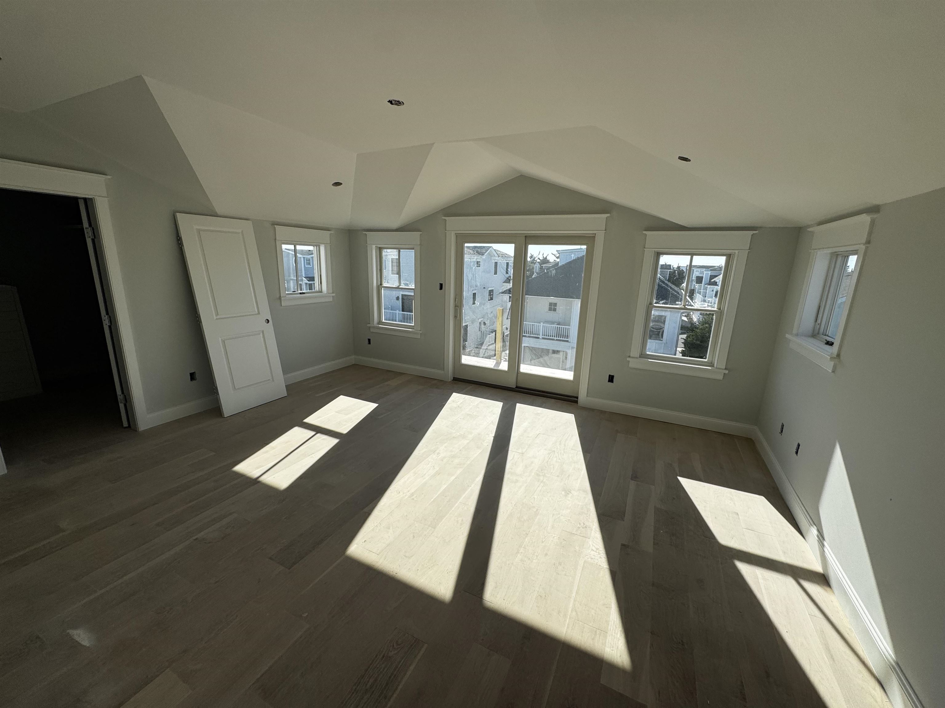 34 West 13th Street Avalon, NJ 08202 - Photo 11 of 28 wooden floor in an empty room with a window