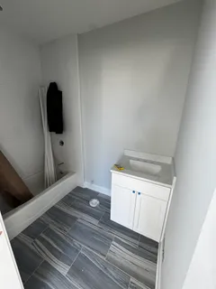 a view of a hardwood floor and utility room