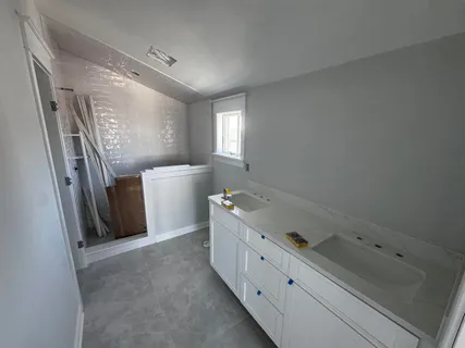 a room with a baby crib and a dresser