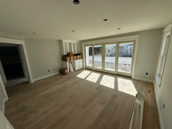 wooden floor in an empty room with a window