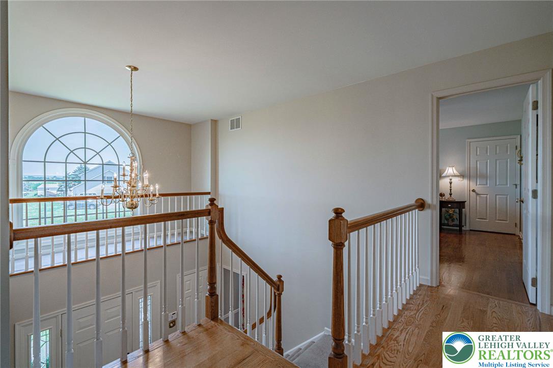 4542 Springfield Drive Coplay, PA 18037 - Photo 38 of 89 Natural light floods this hallway and staircase through a grand arched window.