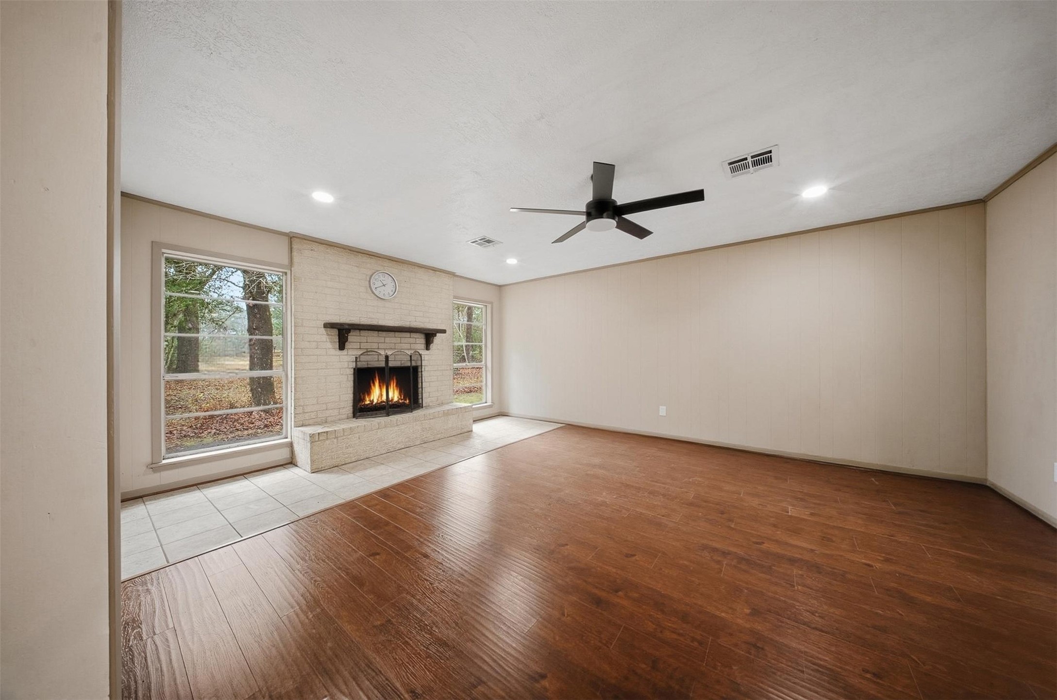 401 Turner Cemetery Road Livingston, TX 77351 - Photo 3 of 34 a view of empty room with wooden floor fireplace and windows