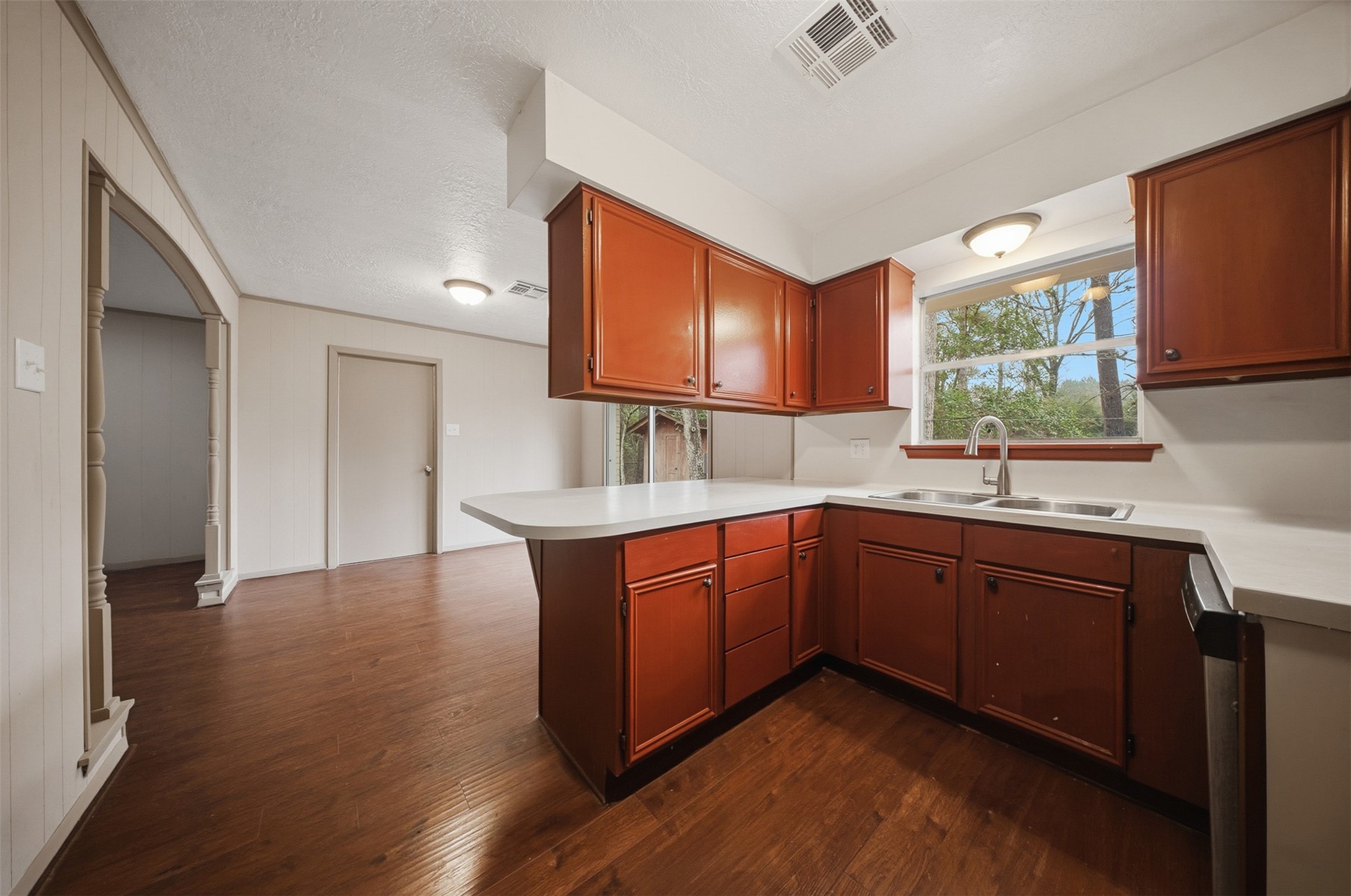 401 Turner Cemetery Road Livingston, TX 77351 - Photo 7 of 34 a kitchen with granite countertop a sink cabinets and wooden floor
