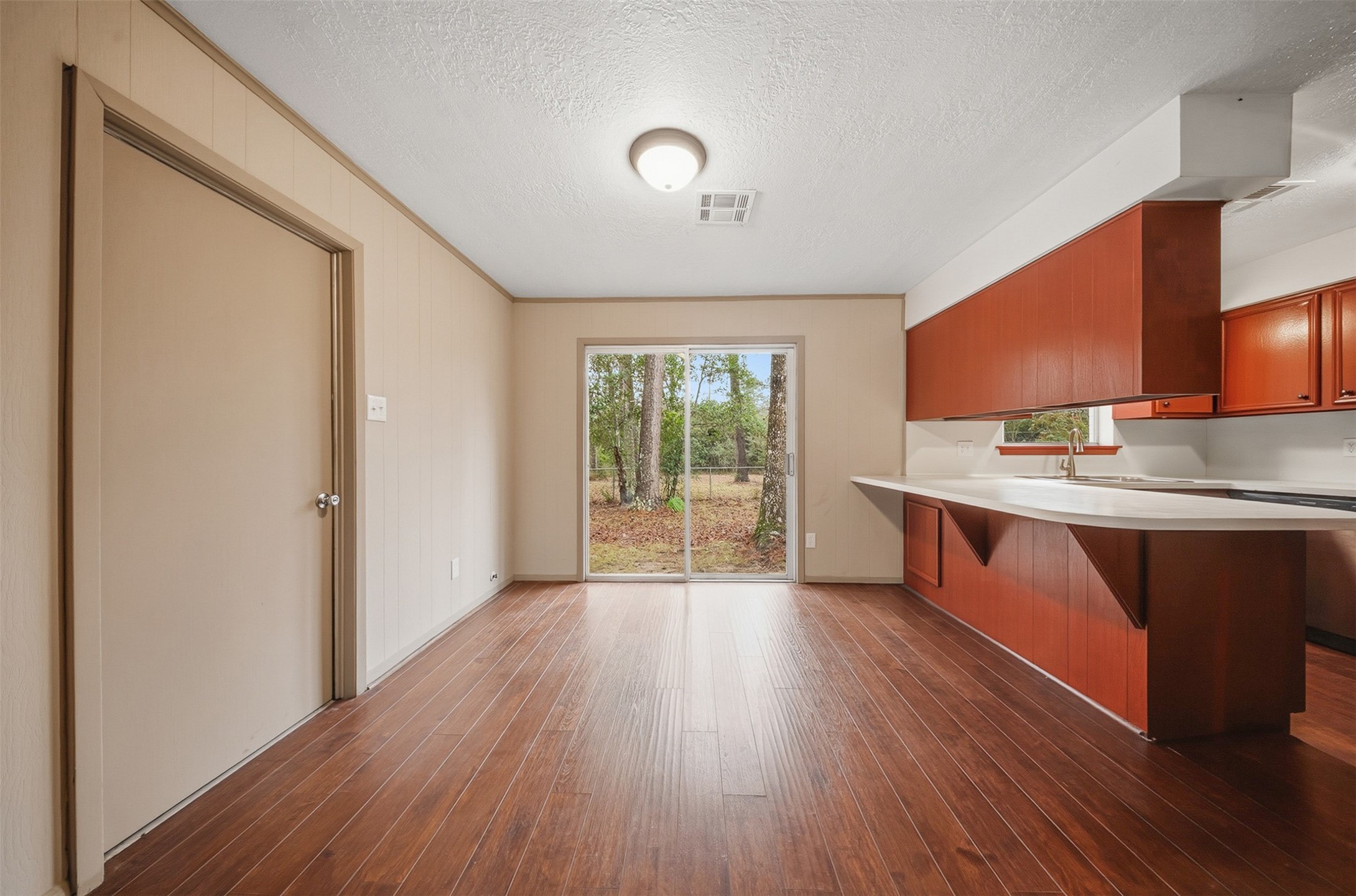 401 Turner Cemetery Road Livingston, TX 77351 - Photo 8 of 34 a large kitchen with a wooden floor and cabinets