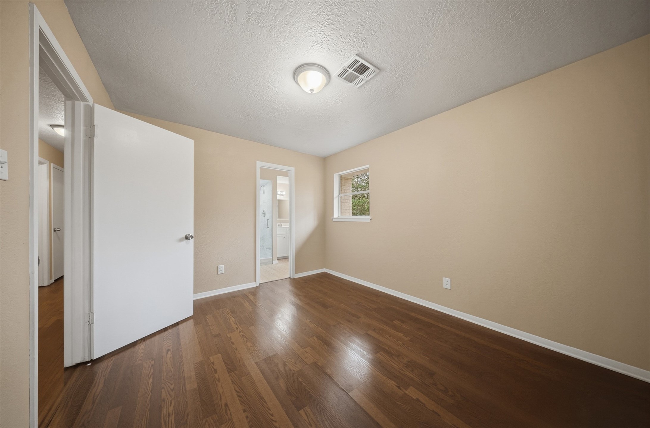 401 Turner Cemetery Road Livingston, TX 77351 - Photo 9 of 34 a view of an empty room with wooden floor and a window