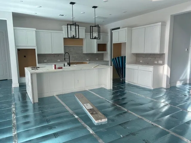 a kitchen with kitchen island a stove a sink and a refrigerator