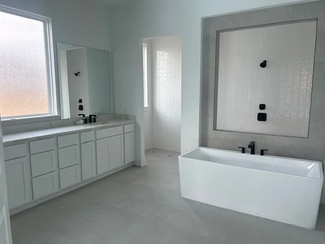 a bathroom with a double vanity sink and mirror with window