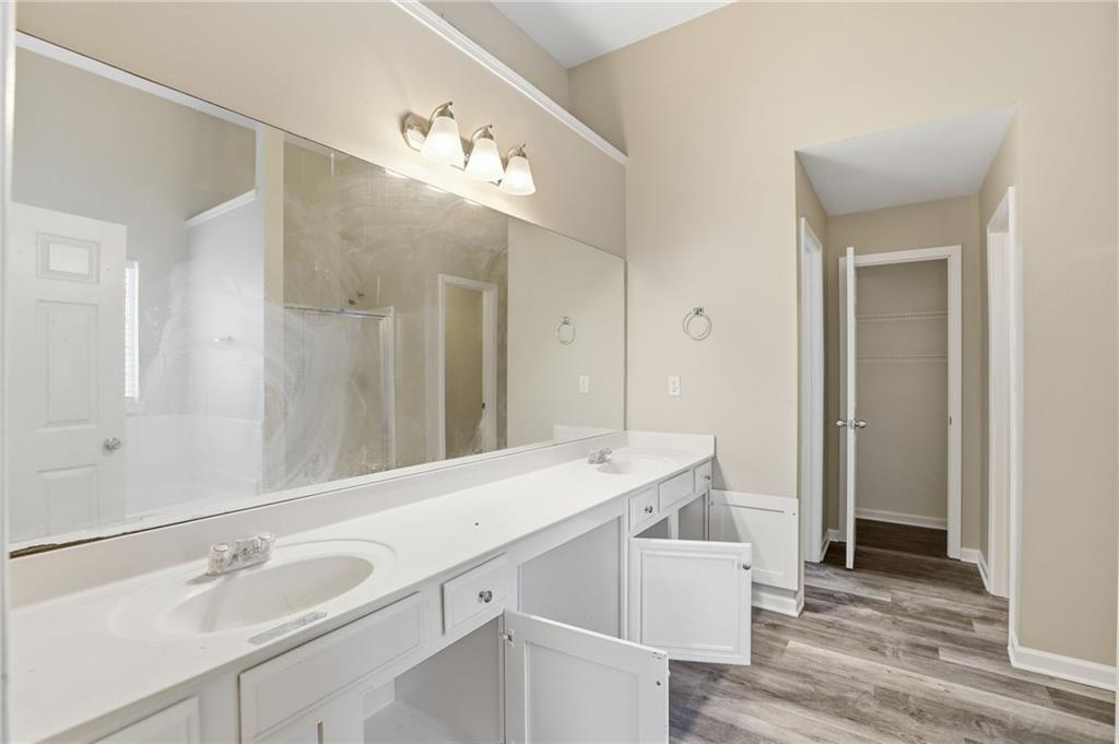 4968 Locherby Drive Fairburn, GA 30213 - Photo 32 of 39 a bathroom with a sink double vanity and a mirror
