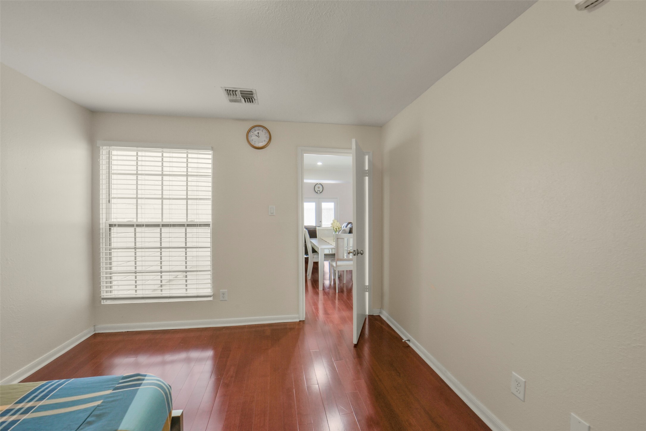 5707 Innsbruck Street Bellaire, TX 77401 - Photo 23 of 35 Primary bedroom is located on the first floor with window overlooking the atrium. Wood floors and lots of natural light.