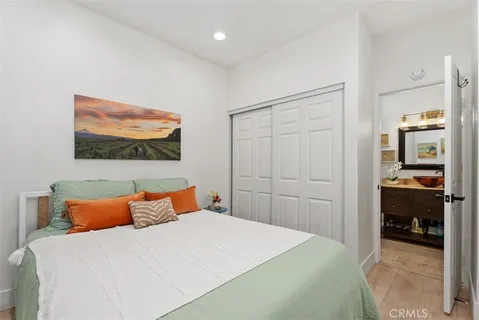 a bedroom with a bed and a painting on the wall