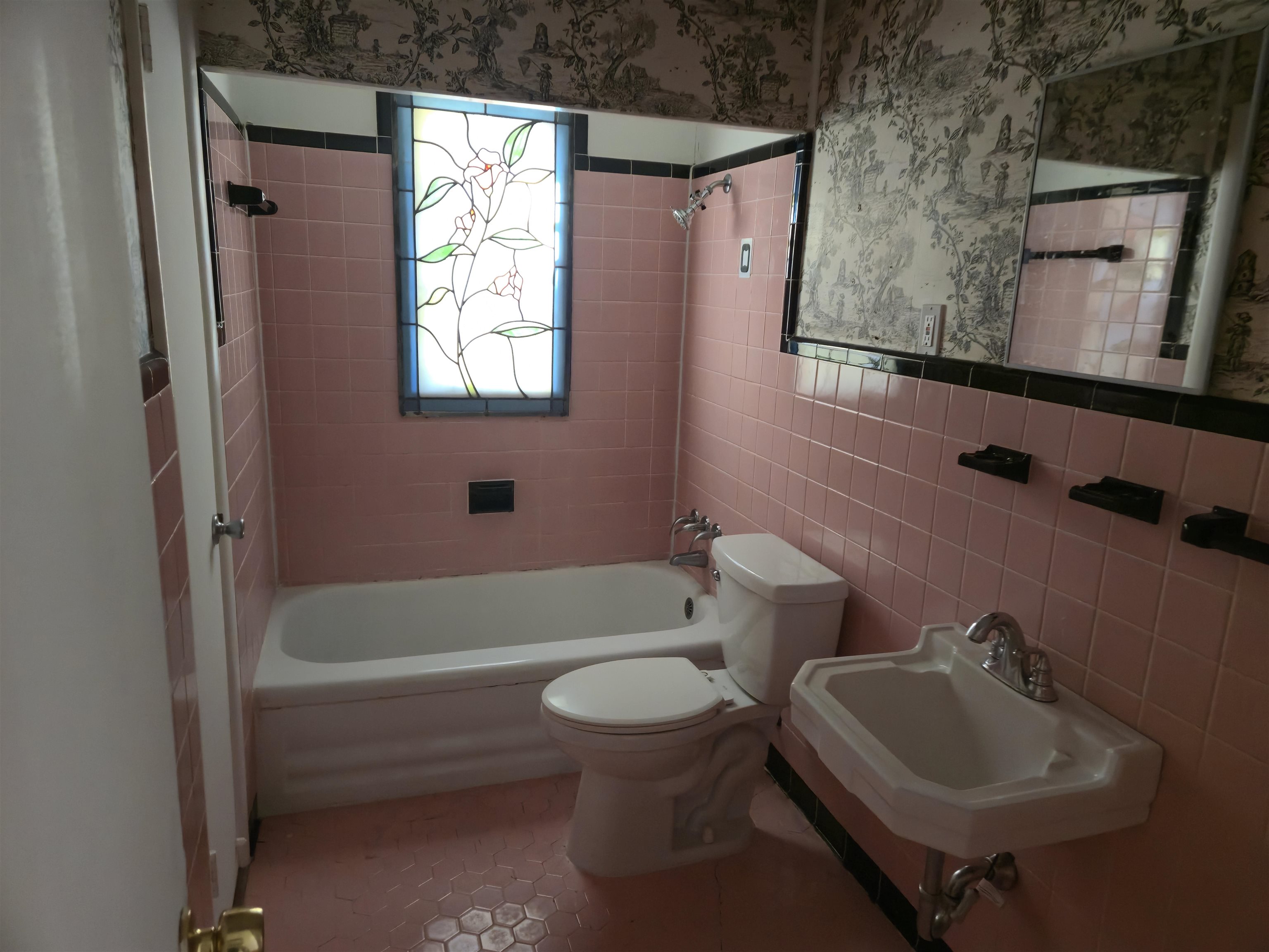1517 Delmont Road Memphis, TN 38117 - Photo 6 of 9 Full bathroom featuring tile walls, tub / shower combination, wallpapered walls, and tile patterned floors