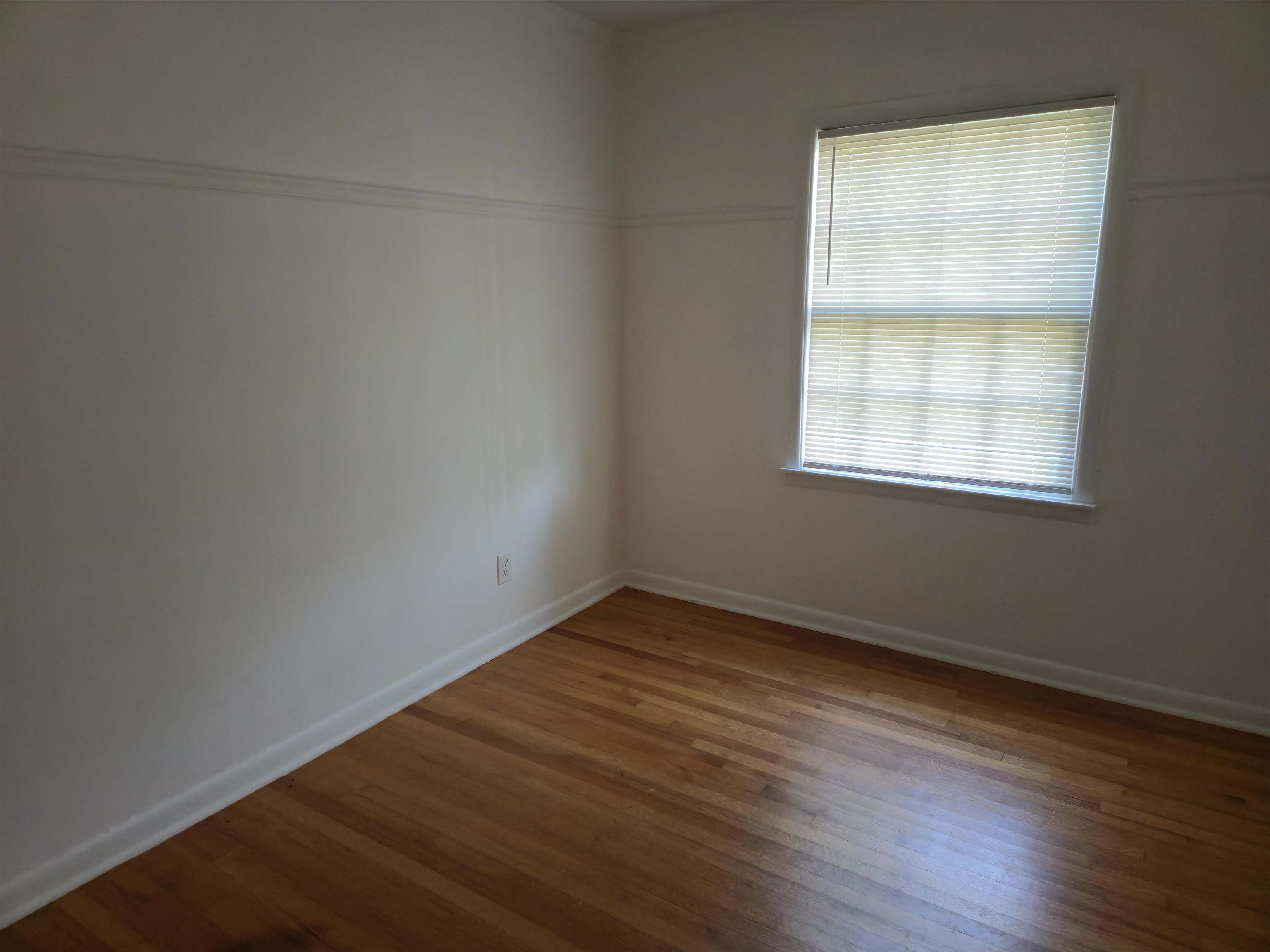 1517 Delmont Road Memphis, TN 38117 - Photo 7 of 9 Unfurnished room with hardwood / wood-style floors and baseboards
