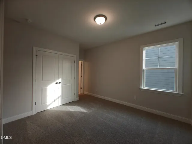 an empty room with a empty space and windows