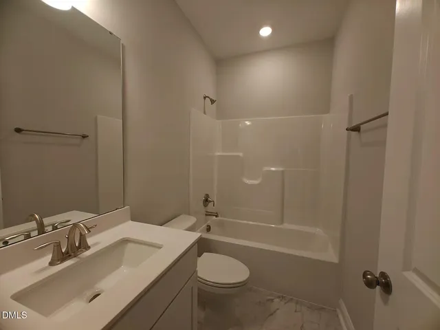 a bathroom with a sink toilet tub and shower