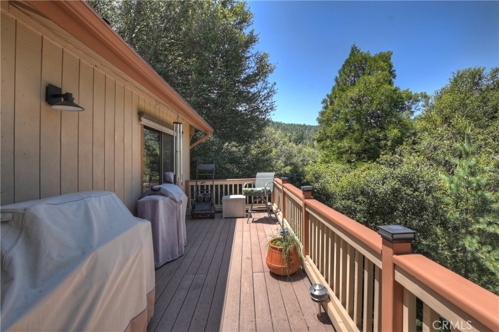 1100 Arbula Drive Crestline, CA 92325 - Photo 13 of 50 a balcony with wooden floor and outdoor seating