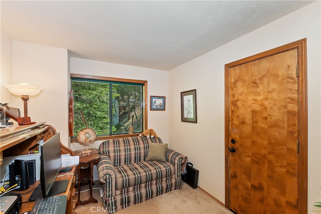 1100 Arbula Drive Crestline, CA 92325 - Photo 24 of 50 a bedroom with a bed and wooden floor