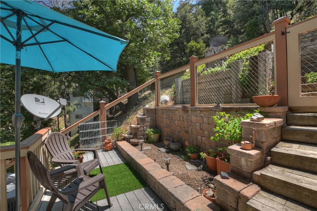 1100 Arbula Drive Crestline, CA 92325 - Photo 37 of 50 a view of a balcony with chairs potted plants