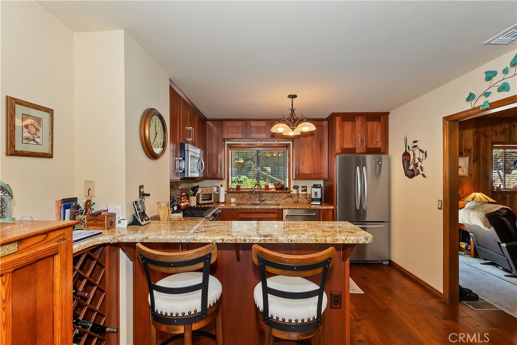 1100 Arbula Drive Crestline, CA 92325 - Photo 9 of 50 a large kitchen with a table and chairs