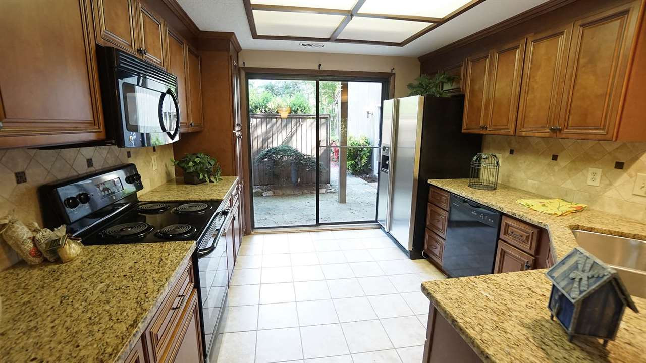 4301 Sun Belt Place Raleigh, NC 27613 - Photo 11 of 23 Kitchen Designed for Food and Fun Together. Sliding Glass Door overlooks Front Patio Kitchen