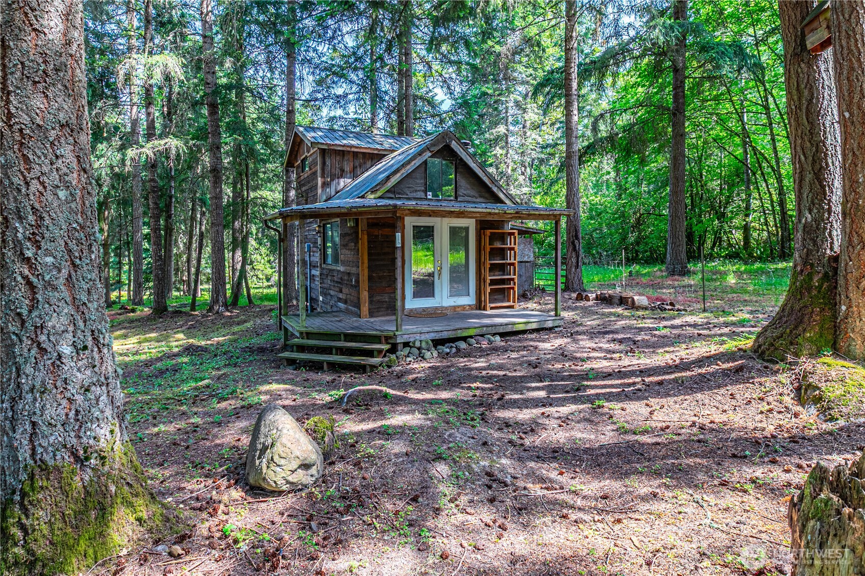 16728 Longmire Road Southeast Yelm, WA 98597 - Photo 16 of 38 a view of a house with yard and trees in the background