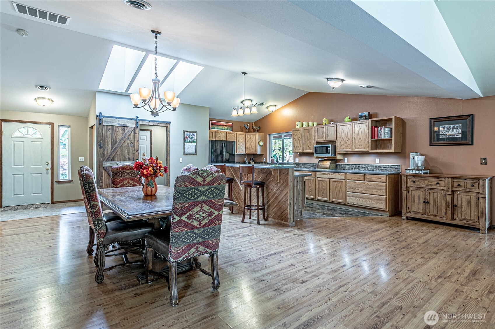 16728 Longmire Road Southeast Yelm, WA 98597 - Photo 19 of 38 a kitchen with kitchen island a dining table and chairs