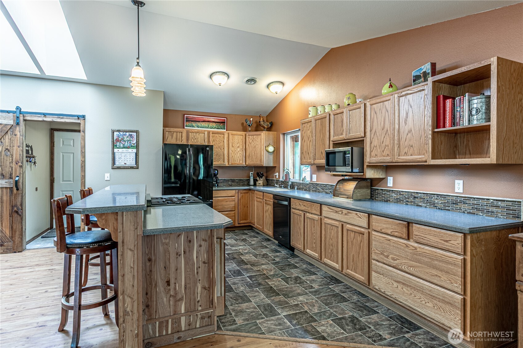 16728 Longmire Road Southeast Yelm, WA 98597 - Photo 20 of 38 a large kitchen with granite countertop lots of counter space and window