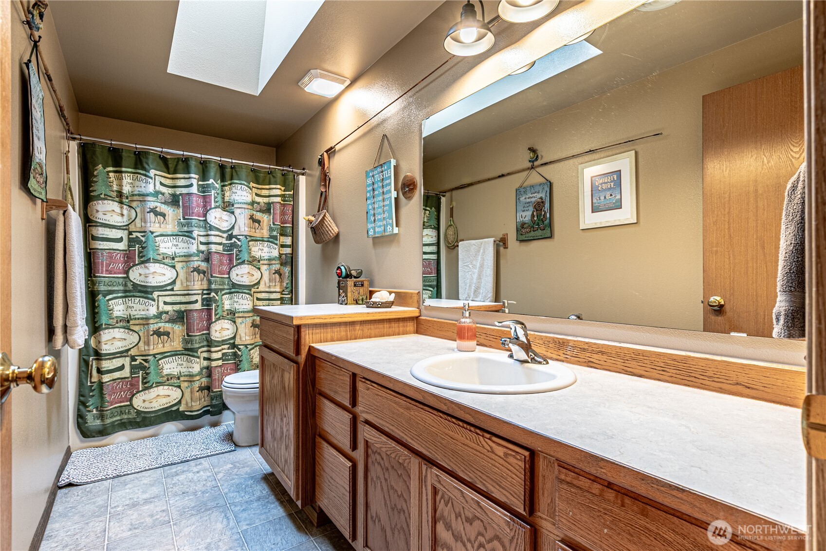 16728 Longmire Road Southeast Yelm, WA 98597 - Photo 33 of 38 a bathroom with a sink a vanity and a mirror