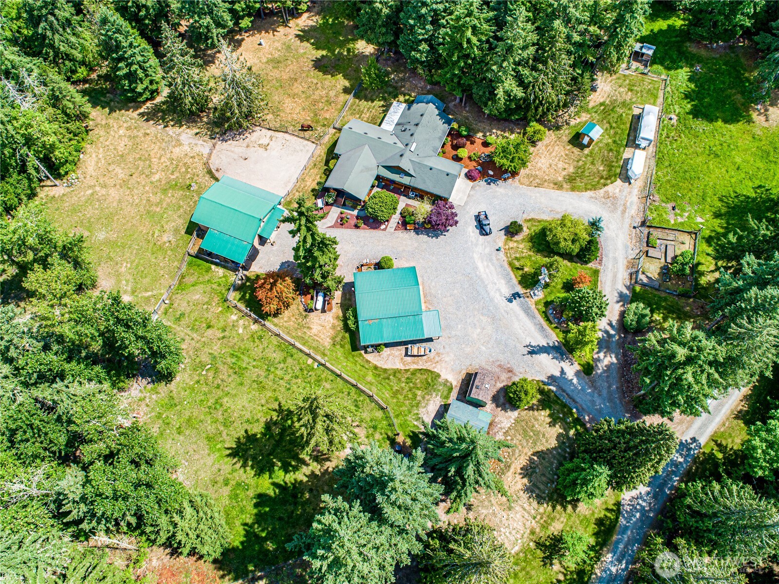 16728 Longmire Road Southeast Yelm, WA 98597 - Photo 4 of 38 an aerial view of a house with a yard and swimming pool