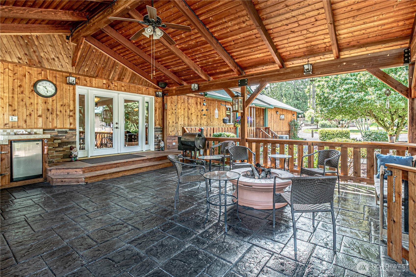 16728 Longmire Road Southeast Yelm, WA 98597 - Photo 9 of 38 a view of a patio with a table chairs and wooden floor