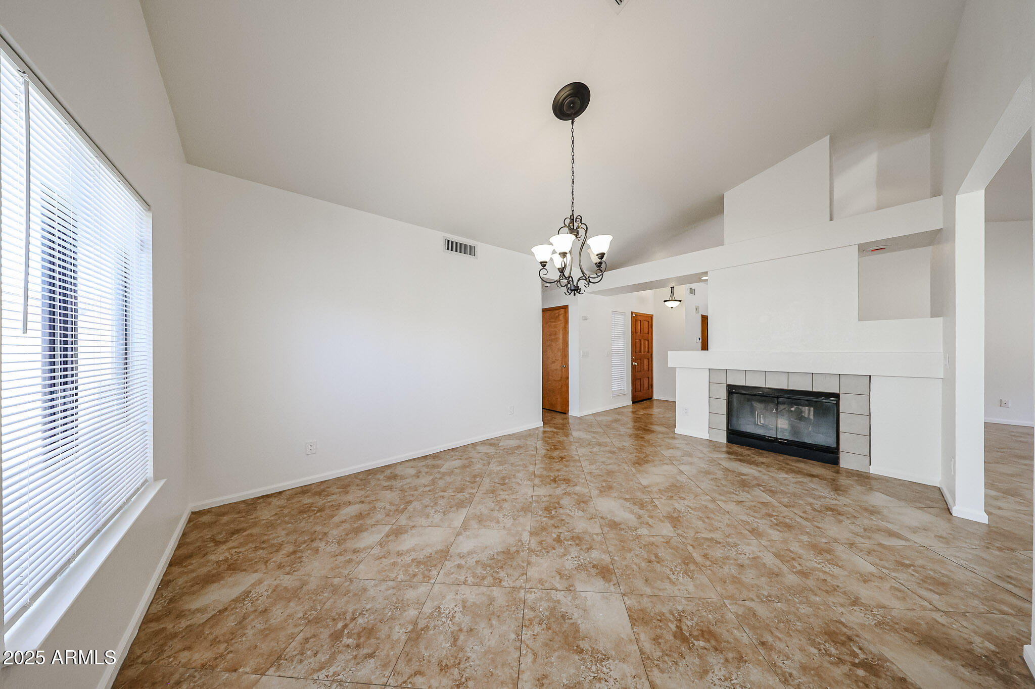1833 East Redfield Road Phoenix, AZ 85022 - Photo 7 of 41 a view of a livingroom with a fireplace and chandelier