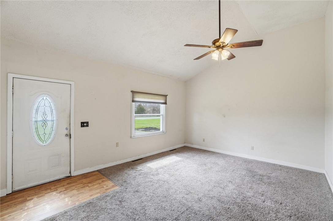 1166 West Sparrow Road Springfield, OH 45502 - Photo 12 of 40 This inviting living area features a bright entryway and offers a cozy, carpeted space for daily living.