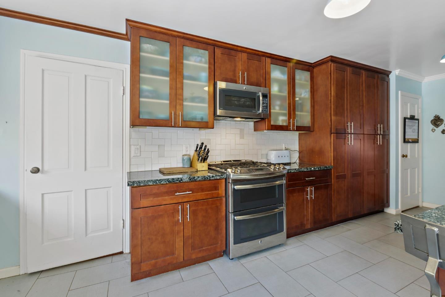 4853 Proctor Road Castro Valley, CA 94546 - Photo 15 of 43 a kitchen with stainless steel appliances granite countertop a stove top oven a sink and dishwasher