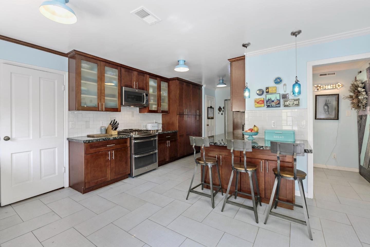 4853 Proctor Road Castro Valley, CA 94546 - Photo 17 of 43 a living room with granite countertop furniture a dining table and kitchen view