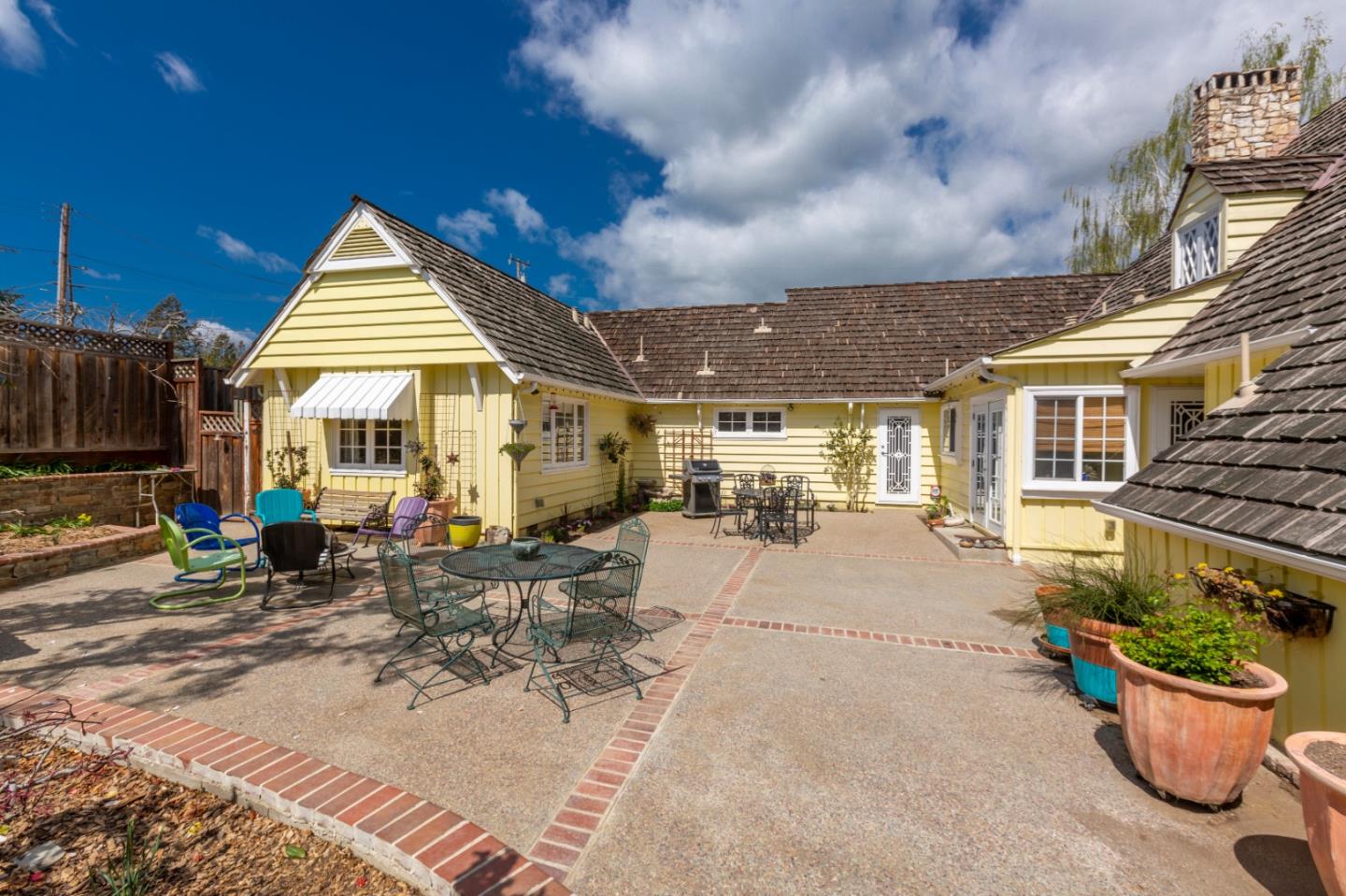 4853 Proctor Road Castro Valley, CA 94546 - Photo 20 of 43 a view of a patio with table and chairs potted plants and a large tree