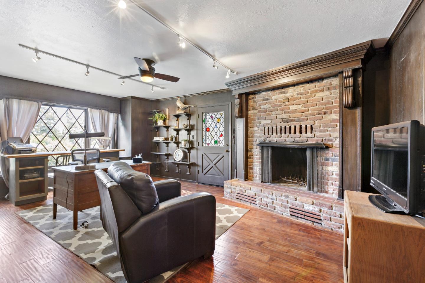 4853 Proctor Road Castro Valley, CA 94546 - Photo 24 of 43 a living room with furniture a flat screen tv and a fireplace