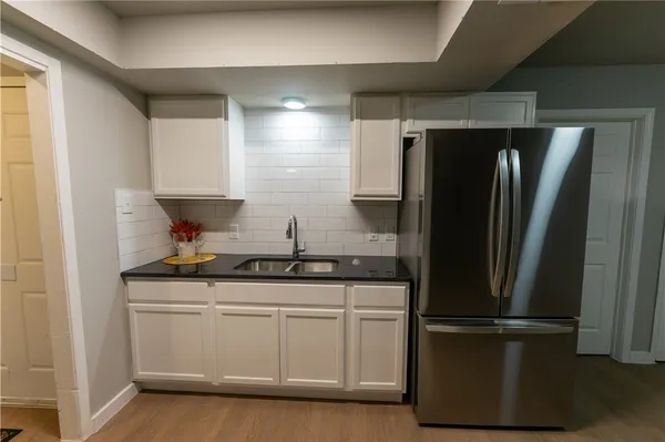 a kitchen with stainless steel appliances a refrigerator and a sink
