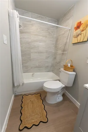 a bathroom with a toilet and a shower